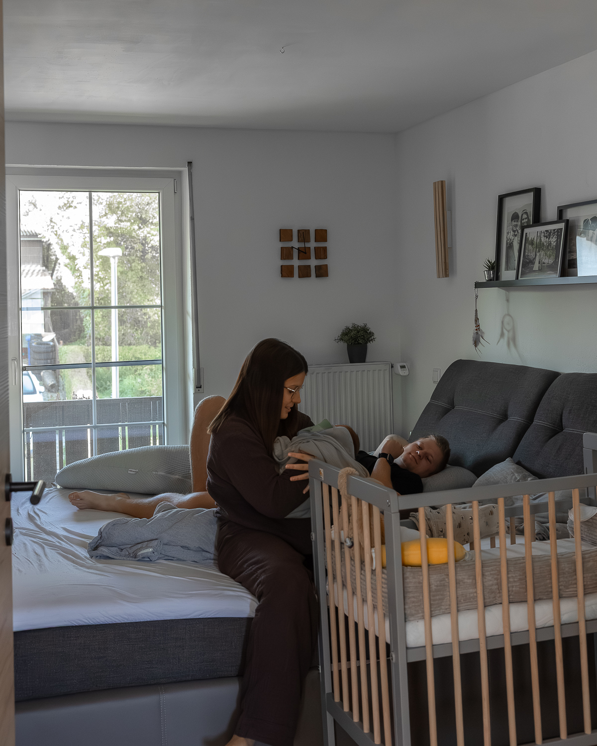 Ehepaar und Neugeborenes im Wochenbett bei dokumentarischer Familienfotografie